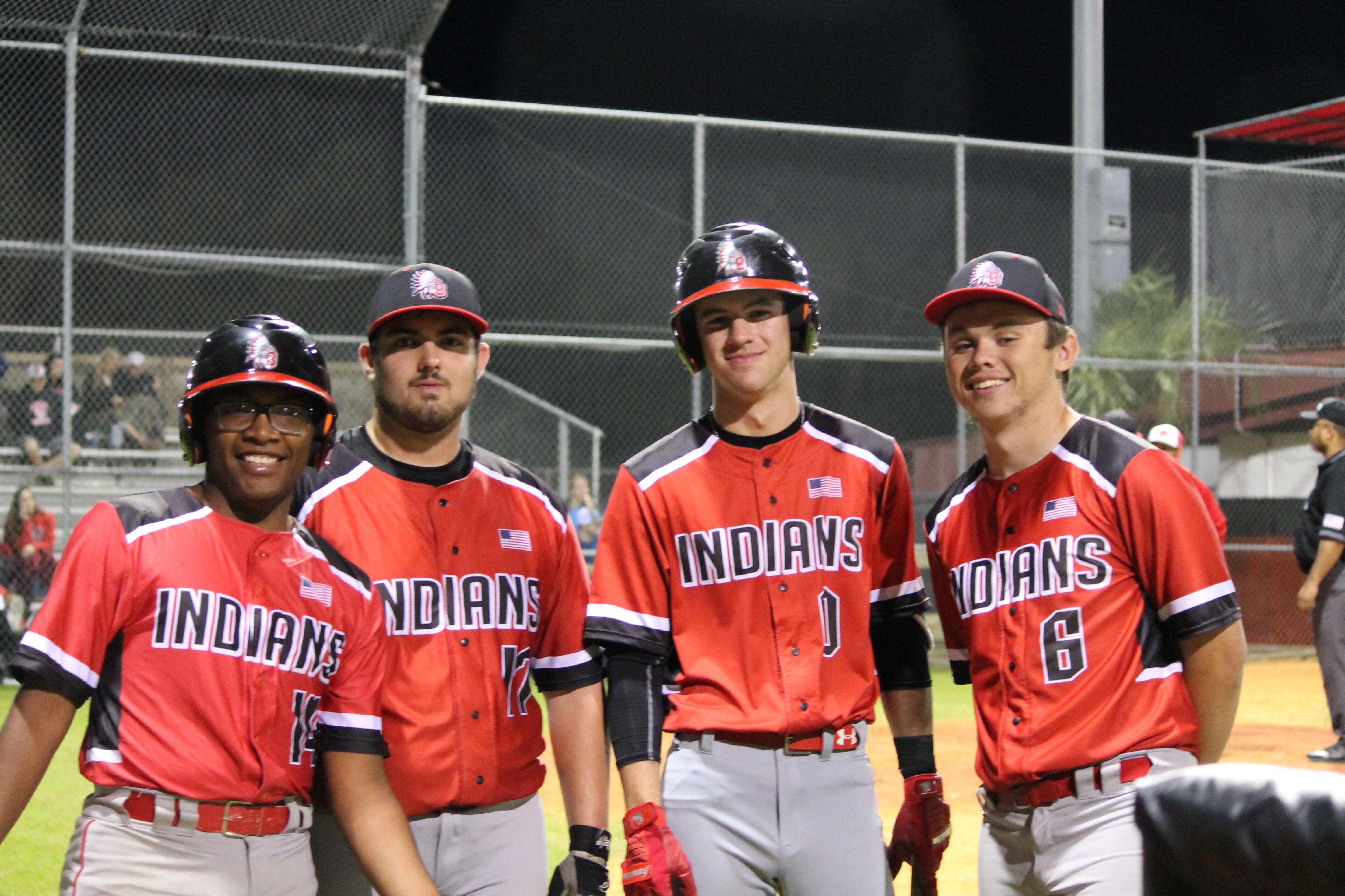  Miggy posing and smiling with his batting helmet on, along side three of his teammates.