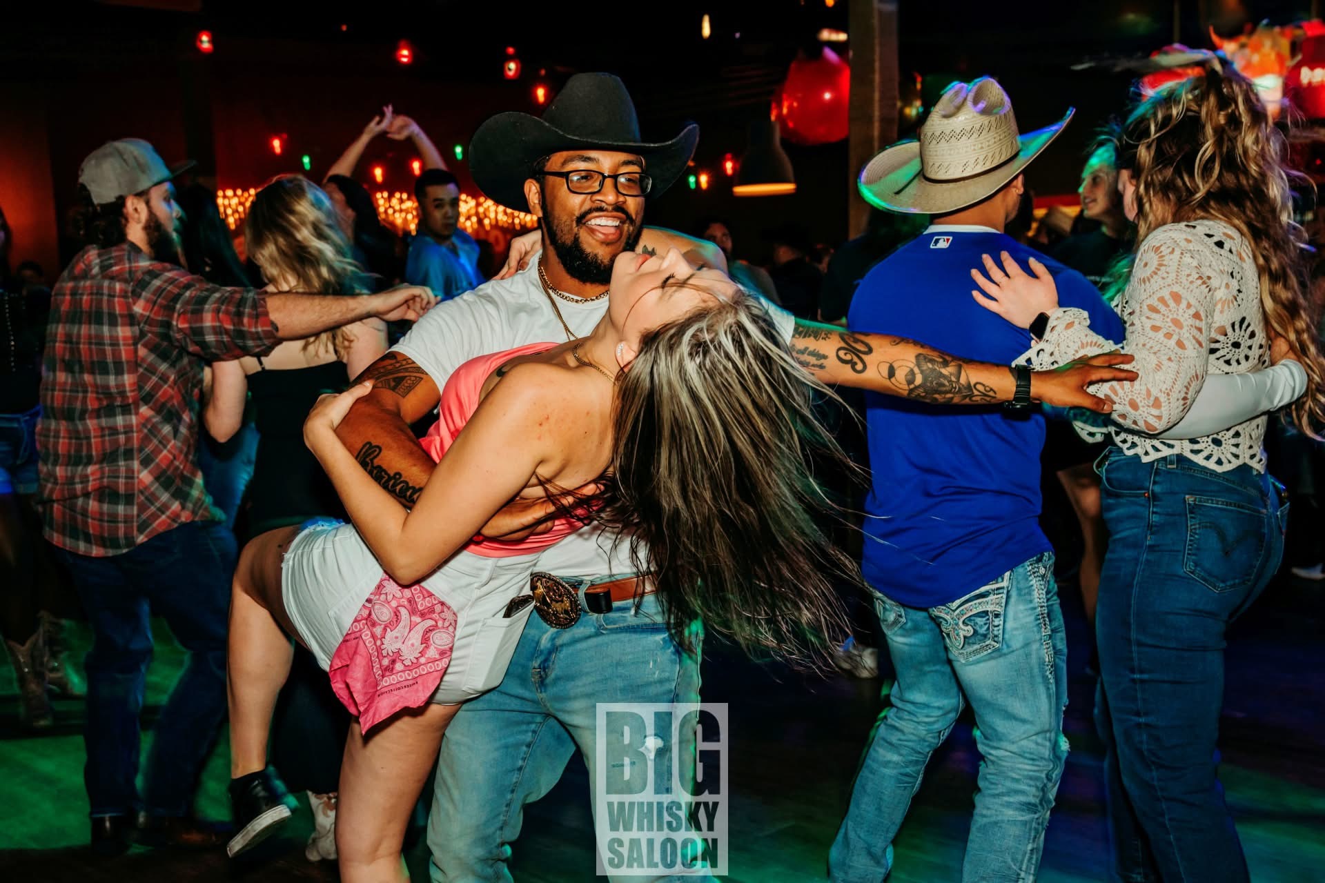 Miggy dipping his girlfriend with one arm during a partner dance.